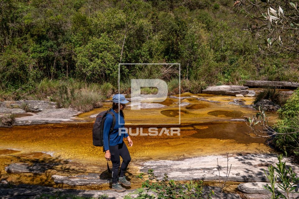 Ecoturista caminhando na margem do Rio do Salto - Parque Estadual do Ibitipoca 
