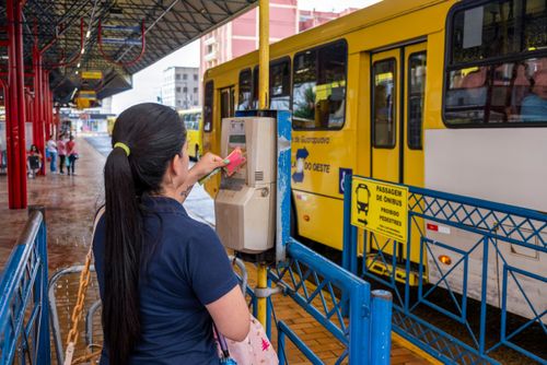 Passageira utilizando cartão de embarque para acesso ao Terminal da Fonte