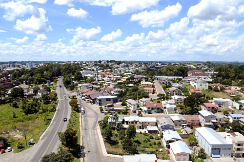 Vista da Rodovia BR-470 e Rua Buarque de Macedo na entrada da cidade com moradias à direita -