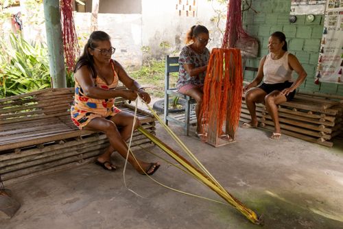 Mulheres extraindo a fibra do buriti na Casa da Artesã no povoado quilombo Marcelino